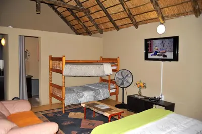 a living room with a bunk bed and a couch at Palmwag Tzaneen in Tzaneen