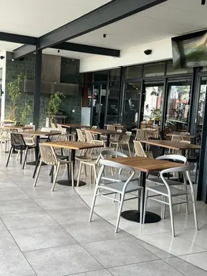 a group of tables and chairs in a restaurant at Lagoon - The Blyde in Pretoria