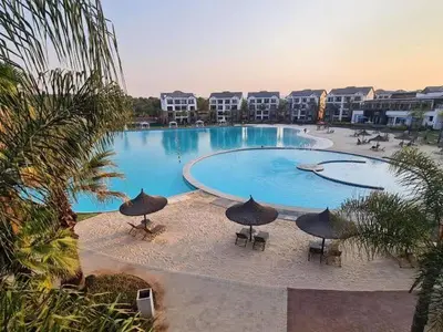 a large swimming pool with umbrellas in a resort at Lagoon - The Blyde in Pretoria