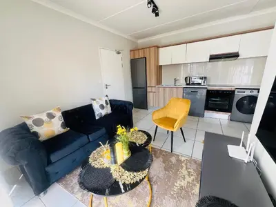 a living room with a couch and a table at Lagoon - The Blyde in Pretoria