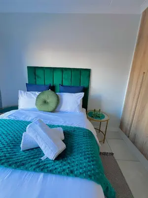 a bed with two towels and a pillow on it at Lagoon - The Blyde in Pretoria