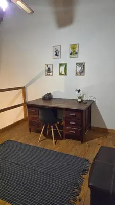 a wooden desk with a chair in a room at Dika Dika Den in Phalaborwa