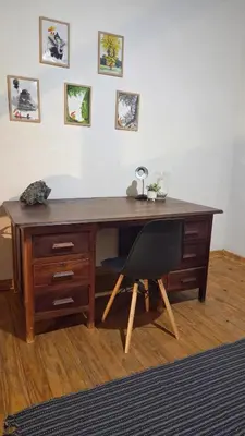 a wooden desk with a black chair in a room at Dika Dika Den in Phalaborwa