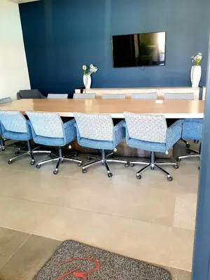 a conference room with a long table and chairs at The Corinthians in Pretoria