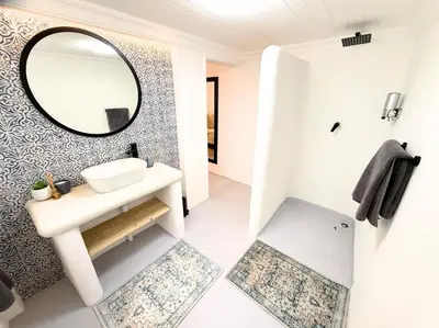 a bathroom with a sink and a mirror at Blanche Guesthouse in Pretoria