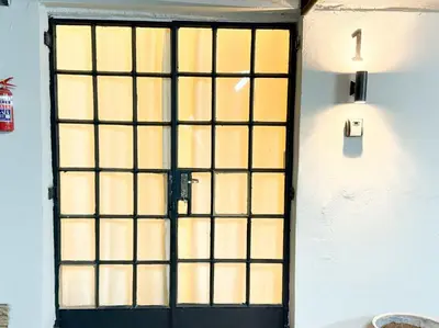 a door with a black gate in a room at Blanche Guesthouse in Pretoria