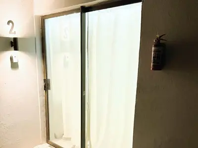 a glass window with a potted plant on the wall at Blanche Guesthouse in Pretoria
