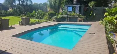 a swimming pool on a wooden deck at Rose Vintage Cottage in Pretoria
