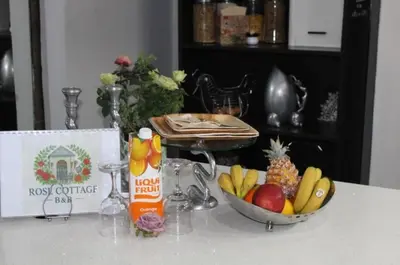 a table with a bowl of fruit on a counter at Rose Vintage Cottage in Pretoria