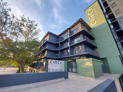a building with a sign on the side of it at Circa 43 1 Bedroom Lynwood in Pretoria