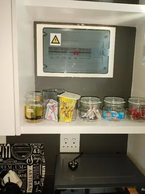 a microwave on a shelf above a kitchen counter at MamelaniQhibi Luxary Apartment in Nelspruit