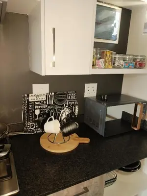 a kitchen with a counter top with a microwave at MamelaniQhibi Luxary Apartment in Nelspruit