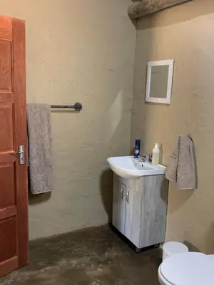 a bathroom with a sink and a toilet at Moyo Safari Lodge in Alldays