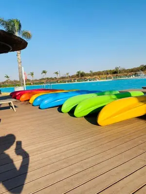 a row of colorful rafts on a deck next to a pool at Cozy abode in Pretoria