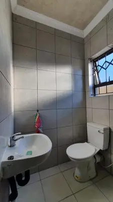 a bathroom with a toilet and a sink at The Hope Apartments in Nelspruit
