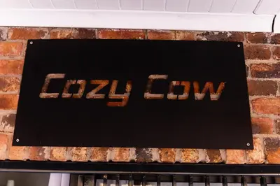 a cake with the word lzil flow on top of a brick wall at Farmco Marloth Park in Marloth Park
