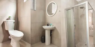 a bathroom with a toilet and a sink and a shower at Matusadona Suites in Mokopane