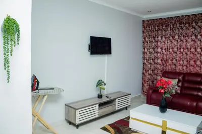 a living room with a red couch and a table at Springs Sleeper's Delight in Springs