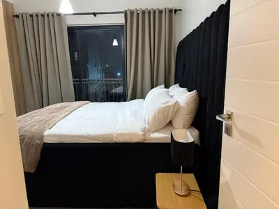 a bedroom with a bed with white pillows and a window at The Dream Stay At The Blyde - Suite 2 in Pretoria