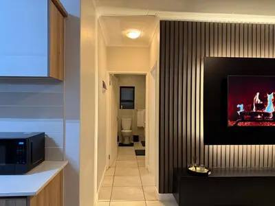 a hallway with a fireplace in a house at The Dream Stay At The Blyde - Suite 2 in Pretoria