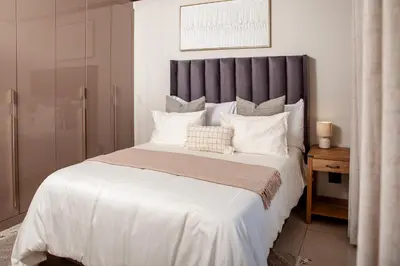 a bedroom with a large bed with white pillows at Ever After Stays in Midrand
