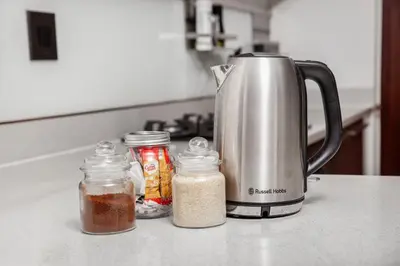 a kitchen counter with a coffee maker and spices at Ever After Stays in Midrand
