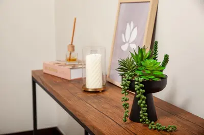 a table with a candle and a potted plant on it at Ever After Stays in Midrand