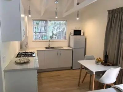 a kitchen with a white refrigerator and a table at African Diamond - Date Night Suite in Benoni