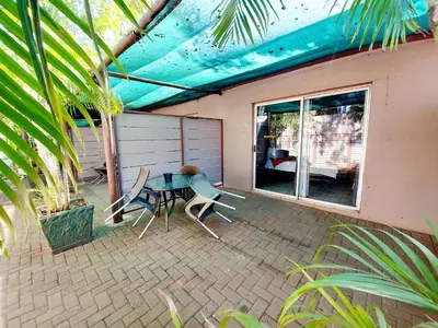 a patio with a table and chairs on it at Sundown Lodge in Komatipoort