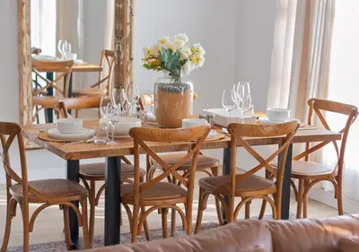a dining room with a table with chairs and flowers at Carlswald Luxe in Midrand