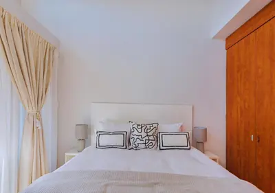 a bedroom with a white bed with two pillows at Carlswald Luxe in Midrand