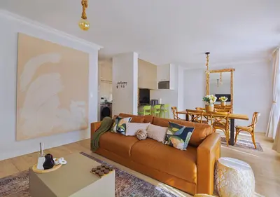 a living room with a couch and a dining room at Carlswald Luxe in Midrand
