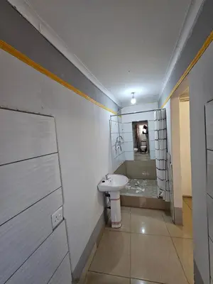 a bathroom with a sink and a bath tub at turfloop guest house in Mankweng