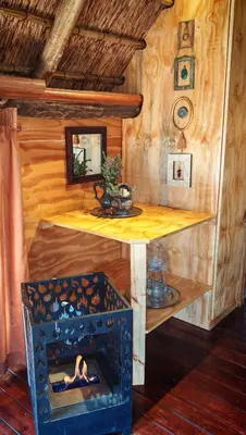 a wooden room with a table and a fireplace at Lethabo Estate in Lanseria