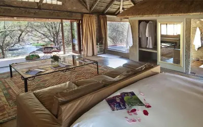 a living room with a couch and a table at Lethabo Estate in Lanseria