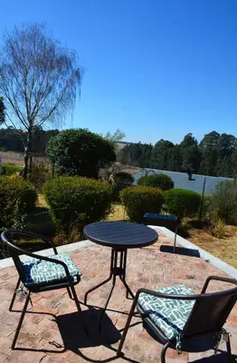 a black table and two chairs and a table and chairs at Dullight Self Cater Cottage in Dullstroom