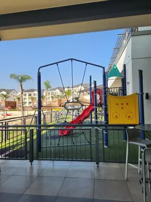 a playground with a slide at a park at Luxury Apartment - The Blyde Crystal Lagoon in Pretoria
