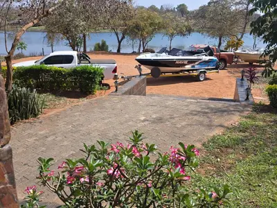 a boat and a truck parked in a driveway at Nandoni Maritime Home in Thohoyandou