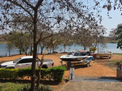 two boats and a car parked next to a lake at Nandoni Maritime Home in Thohoyandou