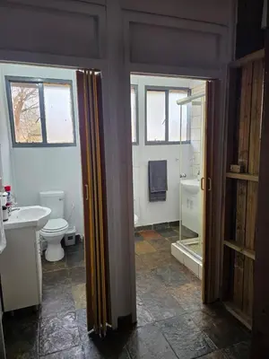 a bathroom with a toilet and a sink and a shower at Nandoni Maritime Home in Thohoyandou