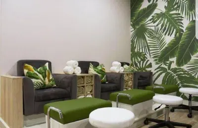a living room with green furniture and plants at The Corinthians Lagoon facing in Pretoria