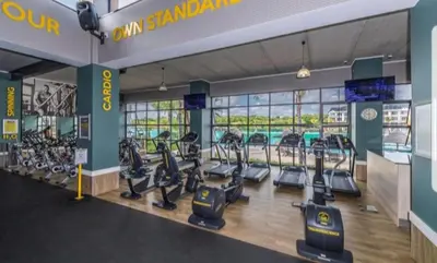 a gym with treadmills and elliptical machines at The Corinthians Lagoon facing in Pretoria