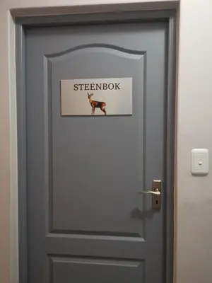 a door with a picture of a deer on it at Valyspruit Trout Fishing and Game Retreat in Dullstroom