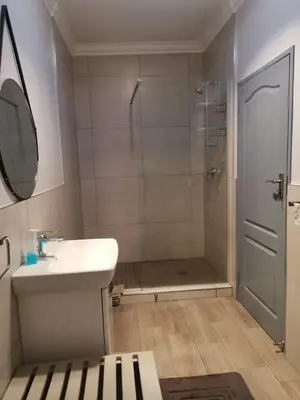 a bathroom with a shower and a sink and a mirror at Valyspruit Trout Fishing and Game Retreat in Dullstroom