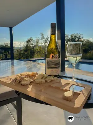 a bottle of wine and a glass of white wine at 99 on Zwartkloof - Luxury Bushveld Retreat in Warmbaths