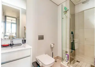 a bathroom with a toilet and a shower at Modern Bachelor Suite & Stunning View Pool & Gym in Midrand