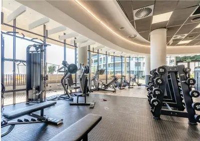 a gym with treadmills and cardio equipment in a building at Modern Bachelor Suite & Stunning View Pool & Gym in Midrand