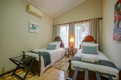 a bedroom with two beds and a window at Just Dandee in Naboomspruit