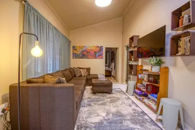 a living room with a couch and a table at Just Dandee in Naboomspruit