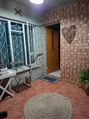 a room with a brick wall with a heart on the wall at Just Dandee in Naboomspruit